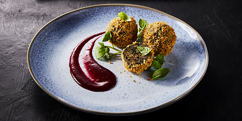 Kale, Chestnut and Mushroom Bonbons with Cherry Sauce - A plate of food on a table - Falafel